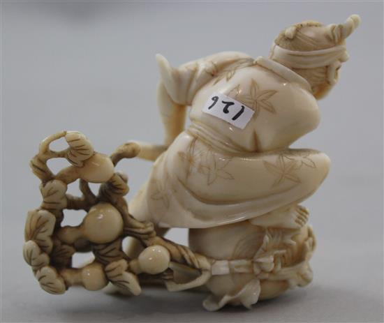 A Japanese ivory okimono of a farmer cutting a large turnip, signed Gyokushi, late 19th / early 20th century, 7cm, slight restorations